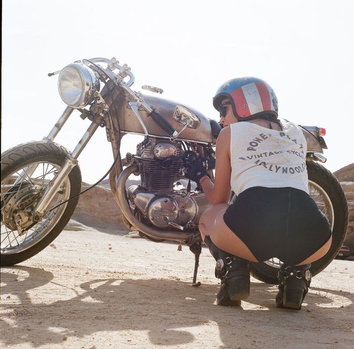 A playful frame from Girls on a motorcycle — online in Surat